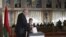 Belarusian President Alexander Lukashenko with his youngest son Nikolai casts his ballot at a polling station during parliamentary elections in Minsk, Belarus, Sunday, Sept. 23, 2012.
