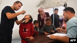 A medic administers a polio vaccine to a Palestinian child at Abdel Aziz Rantissi hospital in Gaza City's Nasr district on Nov. 2, 2024.