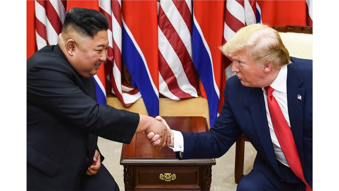 FILE - North Korean leader Kim Jong Un and then-U.S. President Donald Trump shake hands during a meeting on the south side of the Military Demarcation Line that divides North and South Korea, in Panmunjom, June 30, 2019.