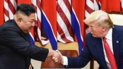 In this file photo taken on June 30, 2019, North Korea's leader Kim Jong Un (L) and US President Donald Trump shake hands during a meeting on the south side of the Military Demarcation Line.