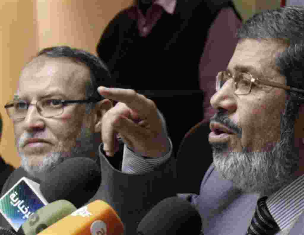 Senior members of Egypt's Muslim Brotherhood Mohamed Morsi, right, and Essam el-Erian hold a press conference on the latest situation in Egypt in Cairo, Egypt, Wednesday, Feb. 9, 2011. (AP Photo/ Mohammed Abou Zaid)