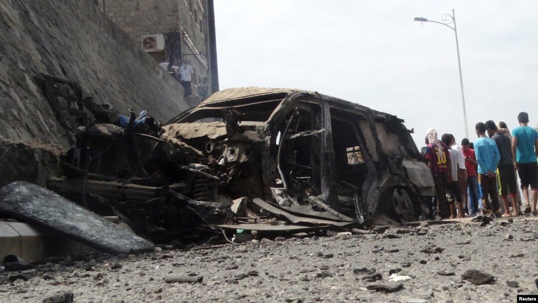 People gather at the site of a car bomb attack that killed the governor of Yemen's southern port city of Aden, Dec. 6, 2015. 