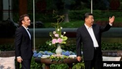 中国领导人习近平在广州一个花园里接待到访的法国总统马克龙。（2023年4月7日）