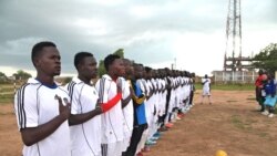 FILE- South Sudan's new football team lines up to sing the national anthem wearing South Sudan shirts for
the first time, June 28, 2012.
