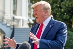 President Donald Trump speaks to reporters outside the White House in Washington, Aug. 7, 2019, before heading to Dayton, Ohio, and El Paso, Texas, to praise first responders and console family members and survivors from two recent mass shootings.