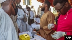 FILE - People queue at a medical laboratory to get tested for Dengue fever in the eastern Gedaref state of War-torn Sudan on September 22, 2023, amid reports of the spread of the viral infection.