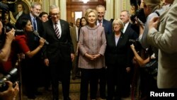 Democratic U.S. presidential candidate Hillary Clinton walks with Senate Minority Leader Harry Reid (D-Nev.) (L), Senator Chuck Schumer (D-N.Y.) (3rd R), Senator Patty Murray (D-Wash.) (2nd R) and Senator Dick Durbin (D-Ill.) (R) as she arrives to meet with Senate Democrats during their luncheon gathering at the U.S. Capitol in Washington, July 14, 2016.