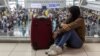 A passenger bound for a flight to Japan waits for her delayed flight at the Ninoy Aquino International Airport, in Pasay City, Metro Manila, Philippines, Jan. 2, 2023. 