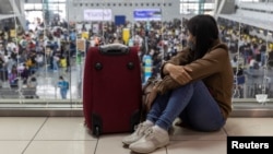 A passenger bound for a flight to Japan waits for her delayed flight at the Ninoy Aquino International Airport, in Pasay City, Metro Manila, Philippines, Jan. 2, 2023. 