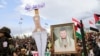 A man holds a picture of Houthi leader Abdul-Malik al-Houthi as protesters, mainly Houthi supporters, participate in a rally to show support to Lebanon's Hezbollah and Palestinians in the Gaza Strip, in Sanaa, Yemen Oct. 25, 2024. 