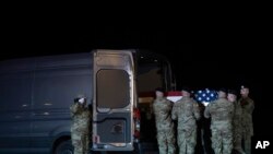 An Army carry team places the transfer case containing the remains of Army Spc. Juan Miguel Mendez Covarrubias, into a transfer vehicle, March 15, 2020, at Dover Air Force Base, Del.