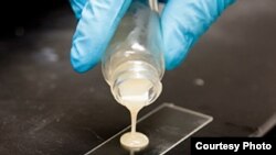 A rubbery compound being applied to a sheet of glass (courtesy: University of Michigan).