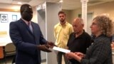 FILE - John Allen and Joyce Krajian, parents of the late Christopher Allen, meet with South Sudan’s ambassador, Phillip Jada Natana in Washington, Aug. 26, 2019. 