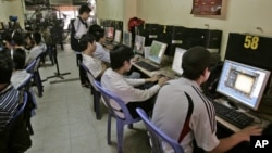 FILE - Students surf web at an Internet cafe in Hanoi, Vietnam, March 31, 2010. (AP Photo/Tran Van Minh)