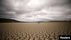FILE - Clouds gather but produce no rain as cracks are seen in the dried up municipal dam in drought-stricken Graaff-Reinet, South Africa, November 14, 2019. (REUTERS/Mike Hutchings)
