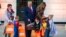 President Donald Trump and first lady Melania Trump give candy to children during a Halloween trick-or-treat event on the South Lawn of the White House which is decorated for Halloween, Monday, Oct. 28, 2019, in Washington. (AP Photo/Alex Brandon)