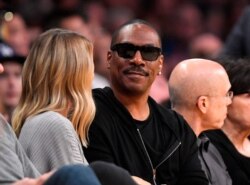 FILE - Actor Eddie Murphy attends an NBA basketball game between the Los Angeles Lakers and the Utah Jazz in Los Angeles, April 8, 2018.