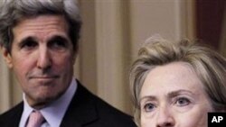 Secretary of State Hillary Rodham Clinton, right, accompanied by Senate Foreign Relations Committee Chairman Sen. John Kerry, D-Mass., left, talks about the START Treaty, on Capitol Hill in Washington, 17 Nov 2010