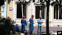 FILE - Investigators and emergency employees work at the site of the place where the downed Ukrainian drone fell in Rostov-on-Don, Russia, Sept. 7, 2023. Russia said 31 Ukrainian drones were intercepted over three regions Tuesday.