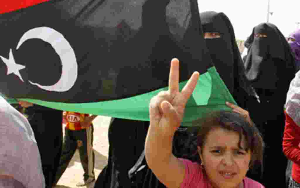 Libyan refugees who fled the unrest in Libya hold a protest against Libyan leader Muammar Gaddafi at a refugee camp near the southern Libyan and Tunisian border crossing of Dehiba, April 28, 2011