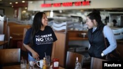 FILE - DACA recipient Barbara Hernandez (L), 26, chats to a friend after eating lunch in a diner in Garden Grove, California, U.S., Jan. 22, 2018.
