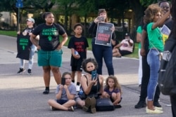 FILE - Demonstrators block a highway access ramp after a march from the state Capitol to the governor's mansion, May 27, 2021, in Baton Rouge, La., protesting the death of Ronald Greene, who died in police custody.