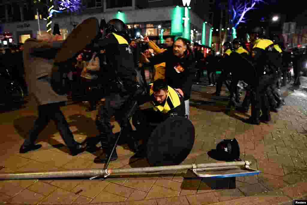 Riot police clash with demonstrators in the streets near the Turkish consulate in Rotterdam, Netherlands, March 12, 2017.