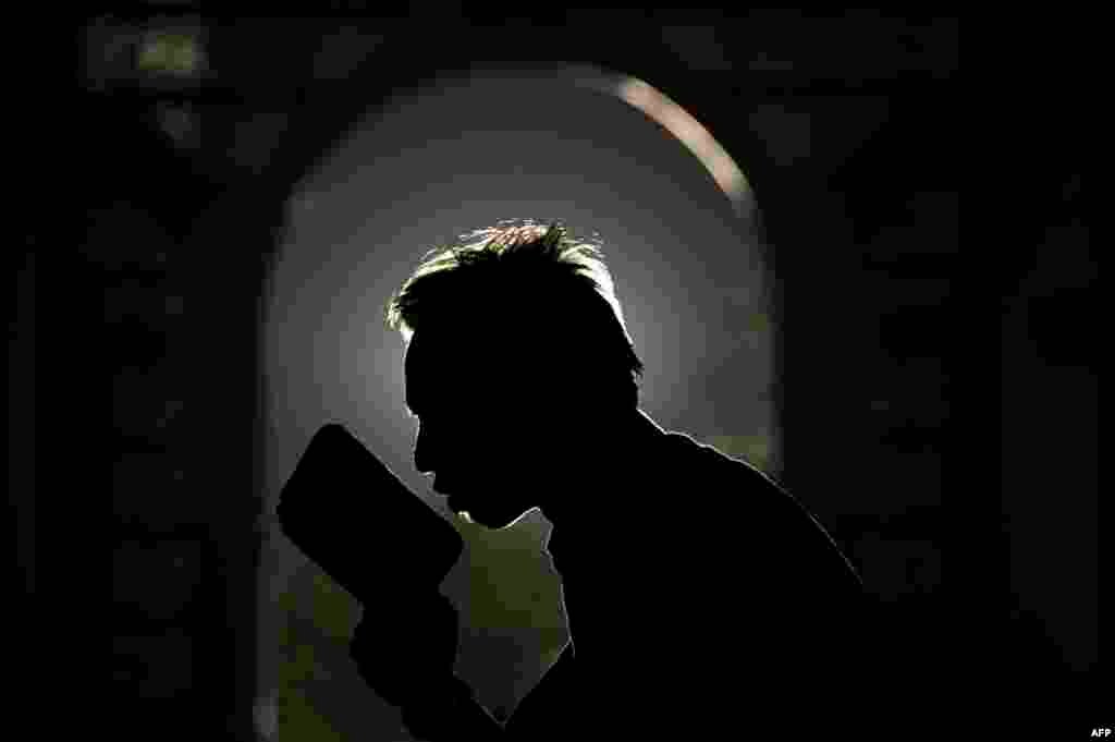 An Indonesian Muslim devotee prays over a Quran as the month of Ramadan continues at a mosque in Surabaya on the eastern Java island.