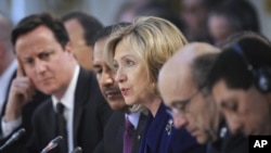 U.S. Secretary of State Hillary Clinton (center) speaks during a conference at the Foreign & Commonwealth Office in London, March 29, 2011