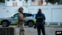 Police officers are seen securing an area near the Israeli embassy in Copenhagen, on October 2, 2024.