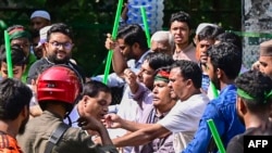 Student protestors beat a suspected supporter of ousted Prime Minister Sheikh Hasina's Awami League party for paying respect to her parent and Bangladesh's founding father Sheikh Mujibur Rahman on his death anniversary, outside his residence in Dhaka on A