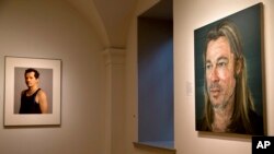 A photograph of John Leguizamo, left, byTimothy Greenfield-Sanders, and a painting of Brad Pitt by Colin Davidson, right, are among the works on display in "Eye Pop: The Celebrity Gaze," at the National Portrait Gallery, May 18, 2015, in Washington. 