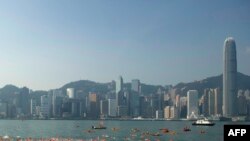 The city skyline is seen in the background as competitors take part in the Harbour Race swimming event in Hong Kong's Victoria Harbour on October 29, 2017. 