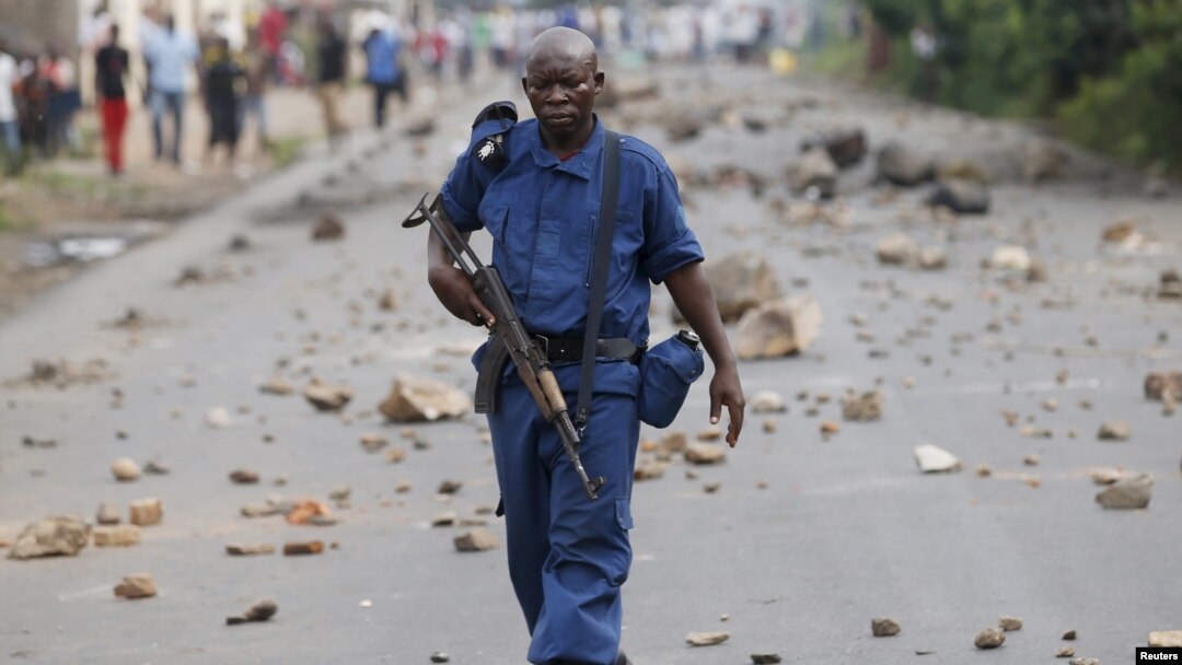 FILE - A policeman holds his rifle during a protest against Burundi President Pierre Nkurunziza in Bujumbura, Burundi, May 20, 2015. 