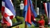 FILE PHOTO: A guard adjusts Cambodia's national flags before a welcoming ceremony at Government House in Bangkok, Thailand, on December 18, 2015. (REUTERS/Athit Perawongmetha)