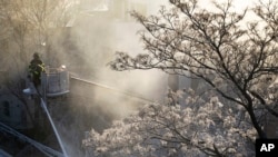 Ice forms on tree branches as firefighters battle a blaze in a commercial building in the Bedford Stuyvesant neighborhood of Brooklyn, New York, Jan. 31, 2019.