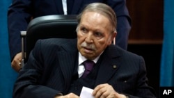 FILE - Algerian President Abdelaziz Bouteflika prepares to vote in Algiers, May 4, 2017.