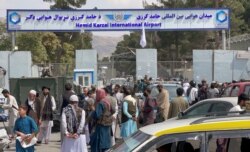 People gather at the entrance gate of Hamid Karzai International Airport a day after U.S troops withdrawal, in Kabul, Afghanistan, August 31, 2021.