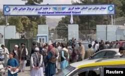 People gather at the entrance gate of Hamid Karzai International Airport a day after U.S troops withdrawal, in Kabul, Afghanistan, August 31, 2021.