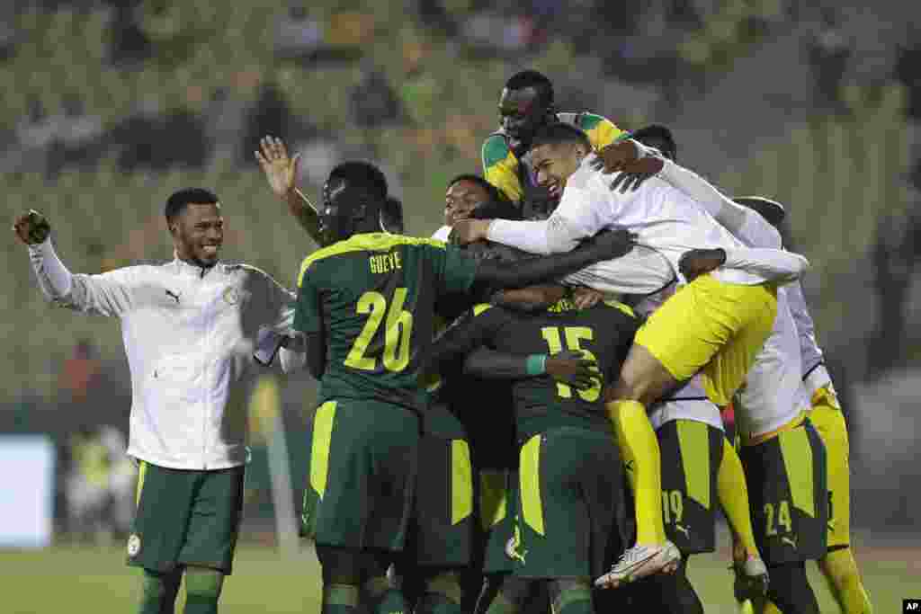 Senegal&#39;s players celebrate after winning the semi-final soccer match against Burkina Faso in Cameroon, Feb. 2, 2022.