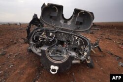 The remains of a U.S. helicopter are seen following an overnight raid by U.S. special operations forces against suspected jihadists in the Syrian northwestern province of Idlib, Feb. 3, 2022.