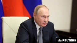 Russian President Vladimir Putin holds talks with Chinese President Xi Jinping via a video link at his residence outside Moscow, Russia December 15, 2021. 