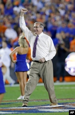 Kent Fuchs appears at a college football game in 2015. He helped the University of Florida gain national recognition for its academic programs. (AP Photo/John Raoux)