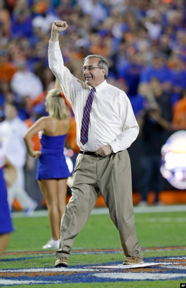 Kent Fuchs appears at a college football game in 2015. He helped the University of Florida gain national recognition for its academic programs. (AP Photo/John Raoux)