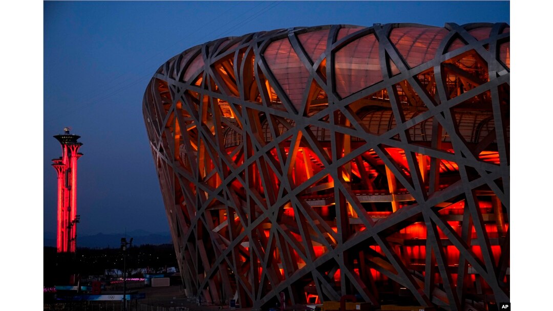 FILE - The National Stadium and the Beijing Olympic Tower are lit in red on the eve of the Chinese New Year, Jan. 31, 2022, China.