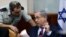 Israel's Prime Minister Benjamin Netanyahu speaks his military secretary Brigadier General Eliezer Toledano, left, during the weekly cabinet meeting at his office, in Jerusalem, Oct. 25, 2015. 