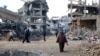 EDITORS NOTE: Graphic content / Palestinians walks amid the destruction in the Shujaiya neighbourhood of Gaza City, in the northern Gaza Strip on January 4, 2025, as the war between Israel and Hamas militants continues. (Photo by Omar AL-QATTAA / AFP)