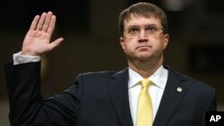 FILE - Veterans Affairs Secretary nominee Robert Wilkie is sworn in at the start of a Senate Veterans Affairs Committee nominations hearing on Capitol Hill in Washington, June 27, 2018.