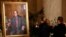 A couple takes photographs of a painting of late U.S. Supreme Court Justice Antonin Scalia in the Great Hall of the Supreme Court in Washington, Feb. 19, 2016.