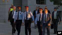 FILE - Catalan regional police chief Josep Luis Trapero, 3rd left, arrives at the national court in Madrid, Oct. 6, 2017. 